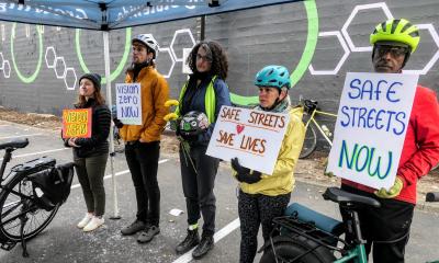Safe streets advocates holding signs